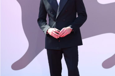 Lewis Pullman in Saint Laurent by Anthony Vaccarello at "The Testament of Ann Lee" photocall in Venice, Italy